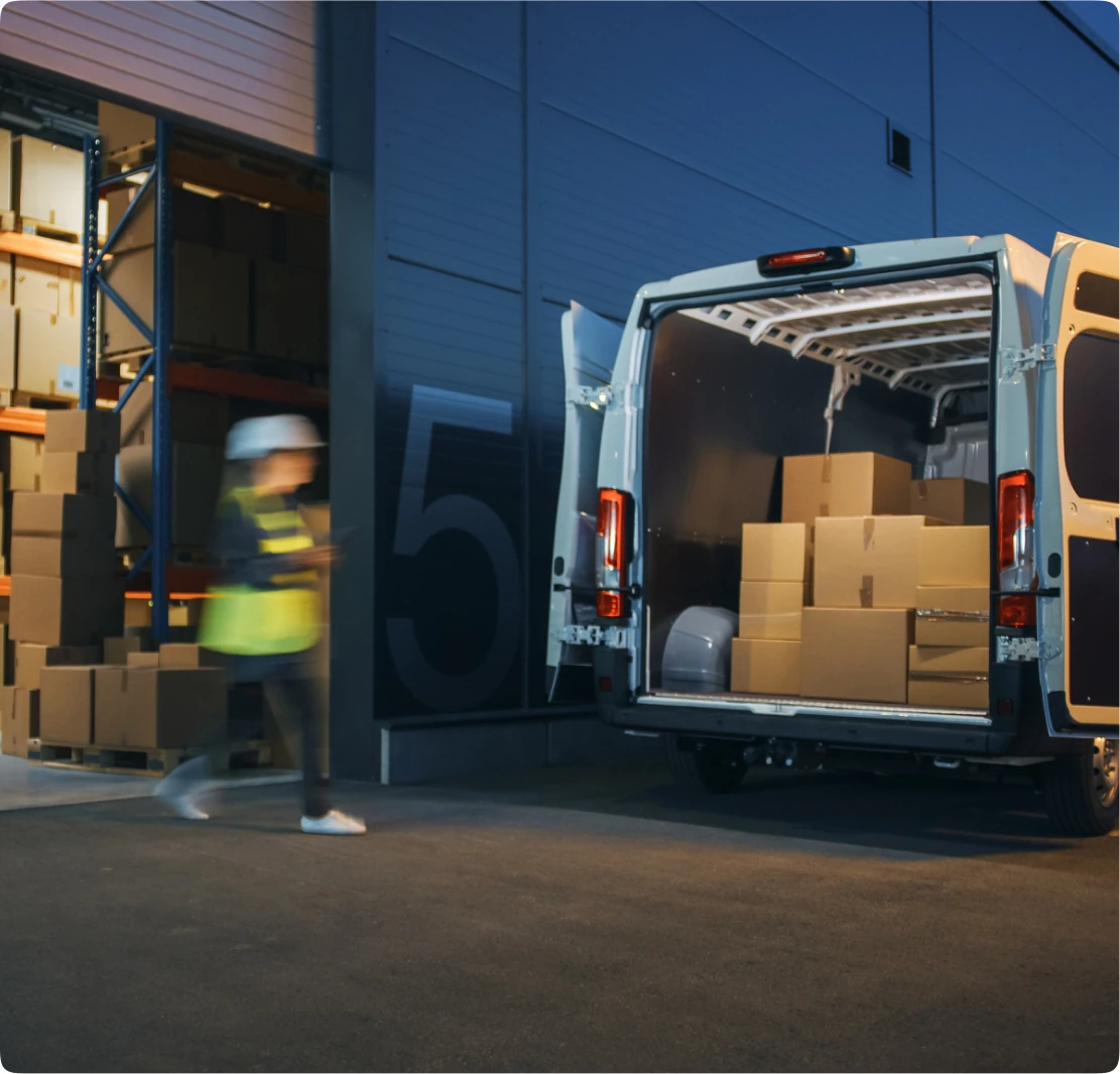 Open delivery van loaded with courier parcels at warehouse dock