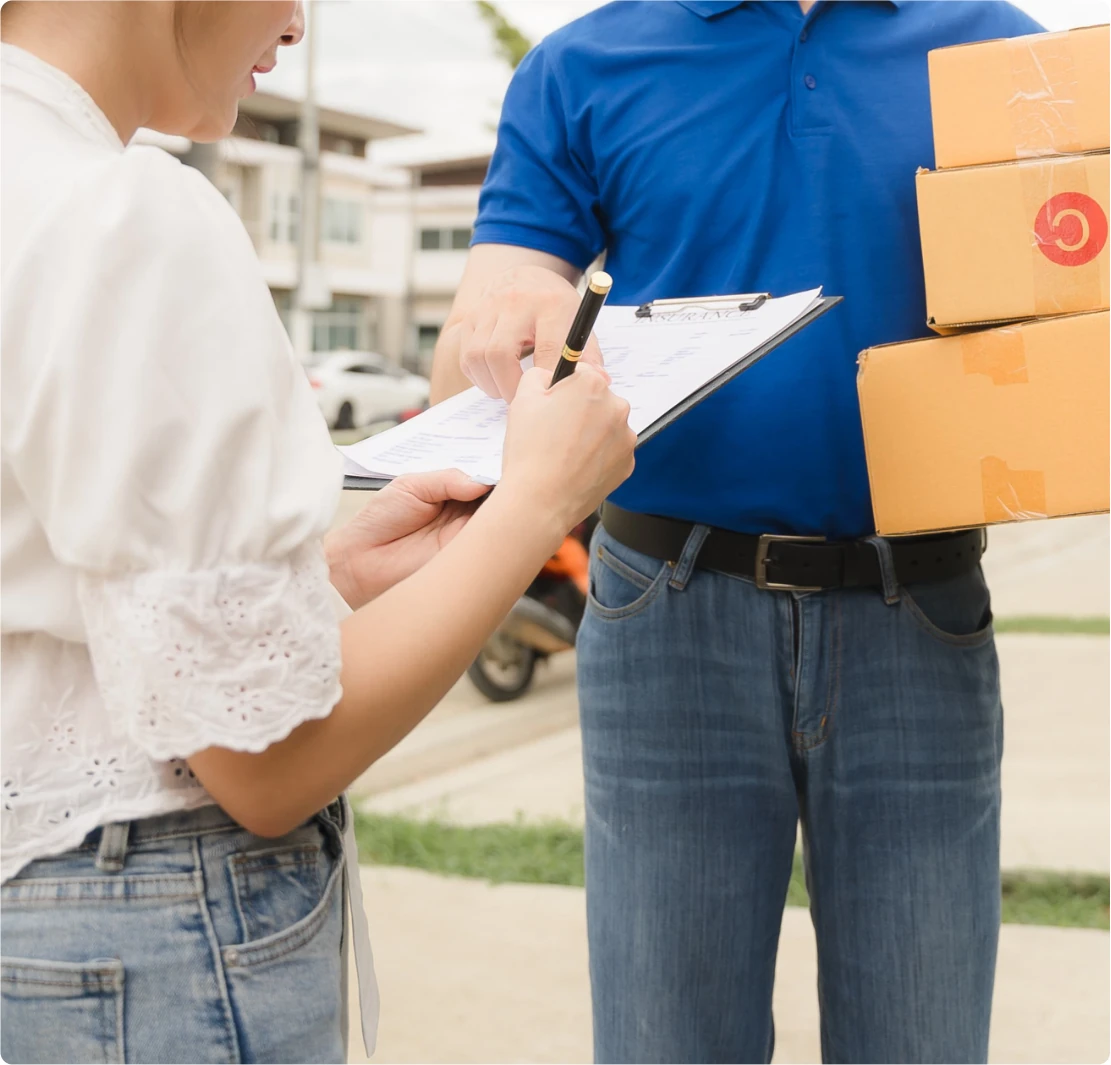 Customer signing electronic delivery proof with courier driver