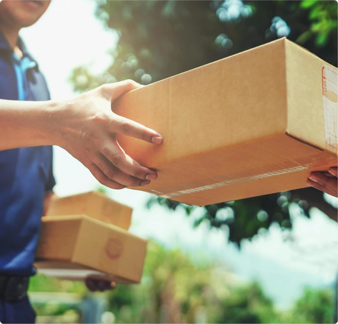 Courier driver handing parcels to customer outdoors