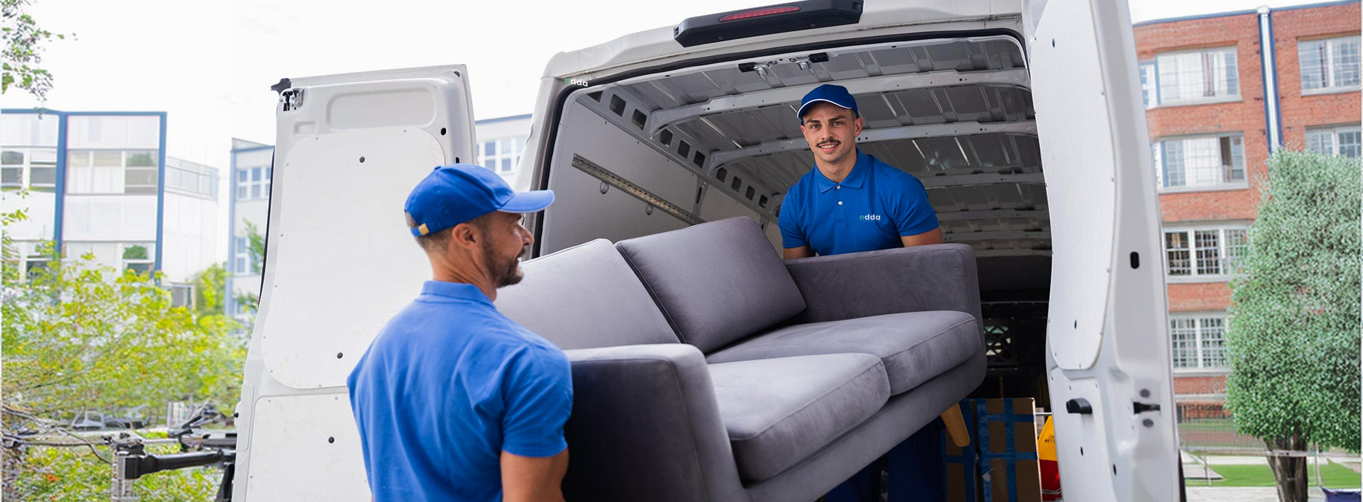 Professional courier driver loading boxes into an open delivery van