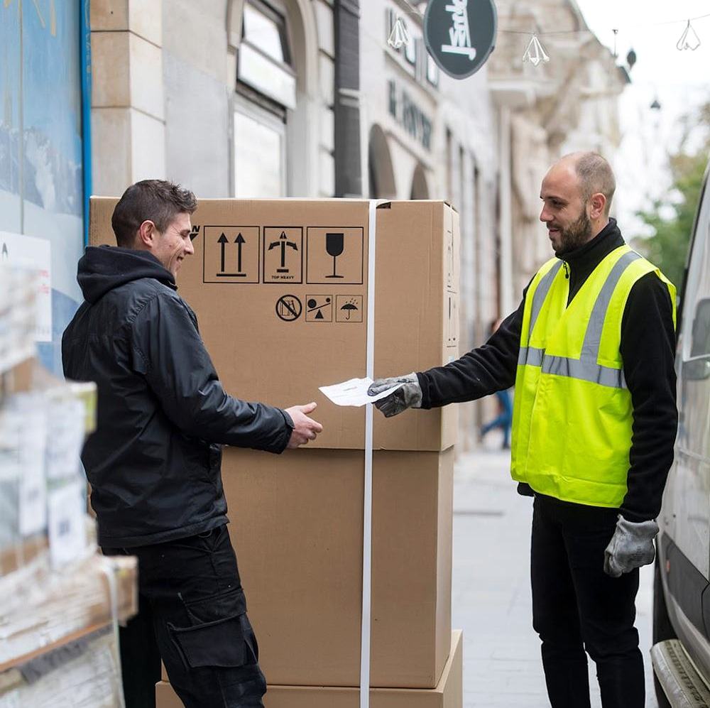 Courier handing paperwork to a customer during a delivery