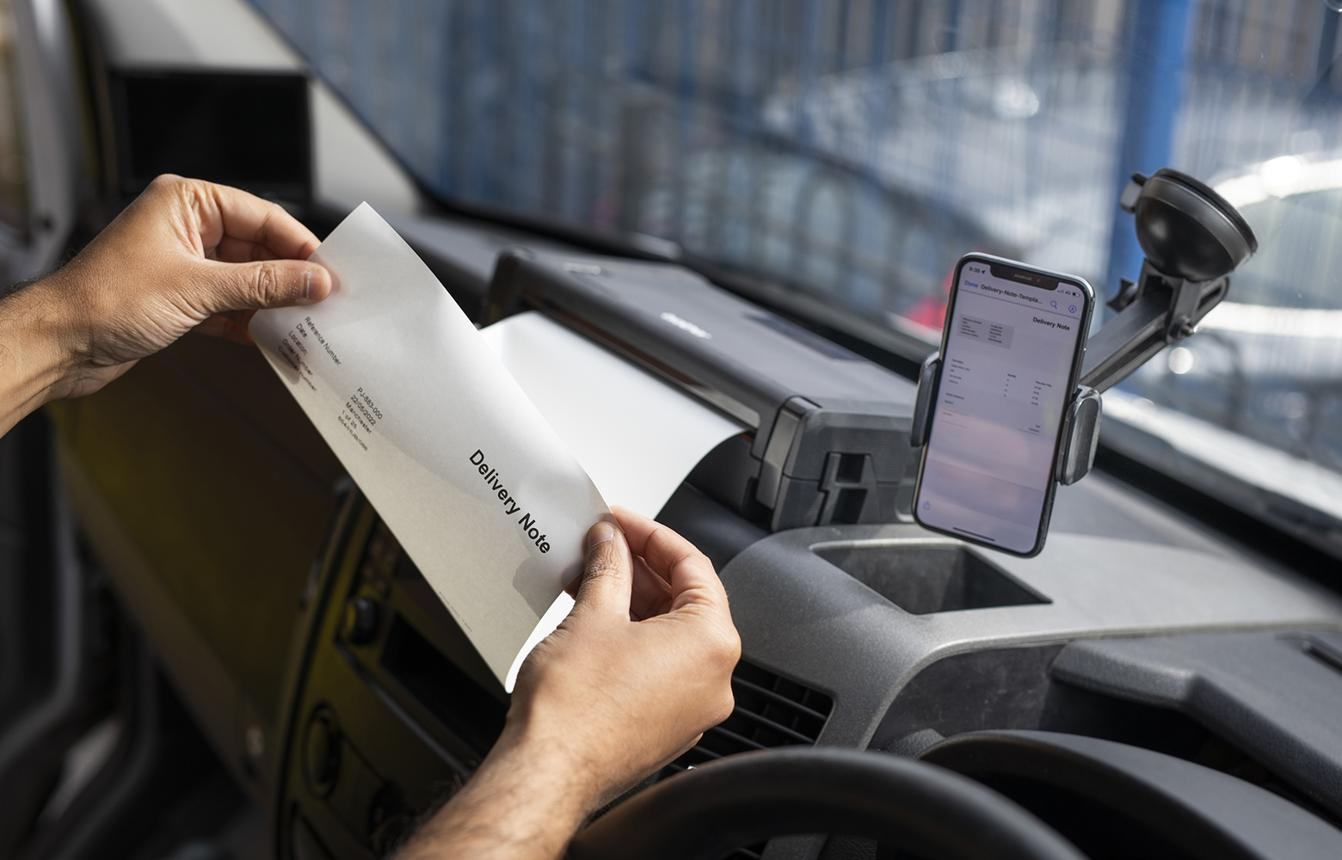 Courier printing a delivery note from inside a vehicle
