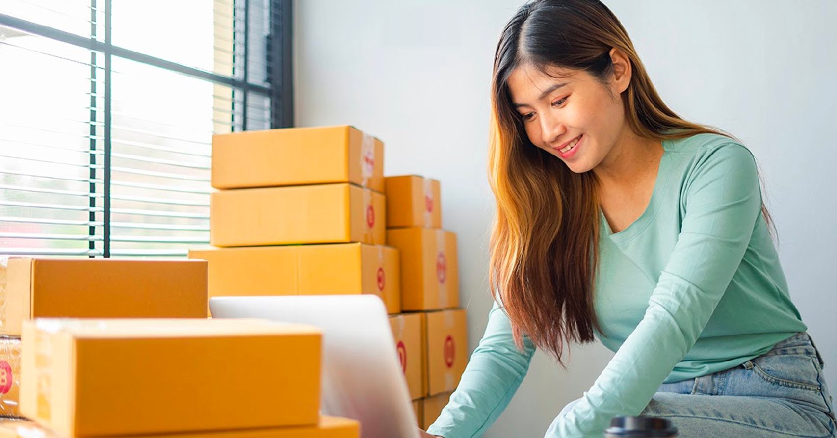 Retail business owner arranging customer parcel deliveries