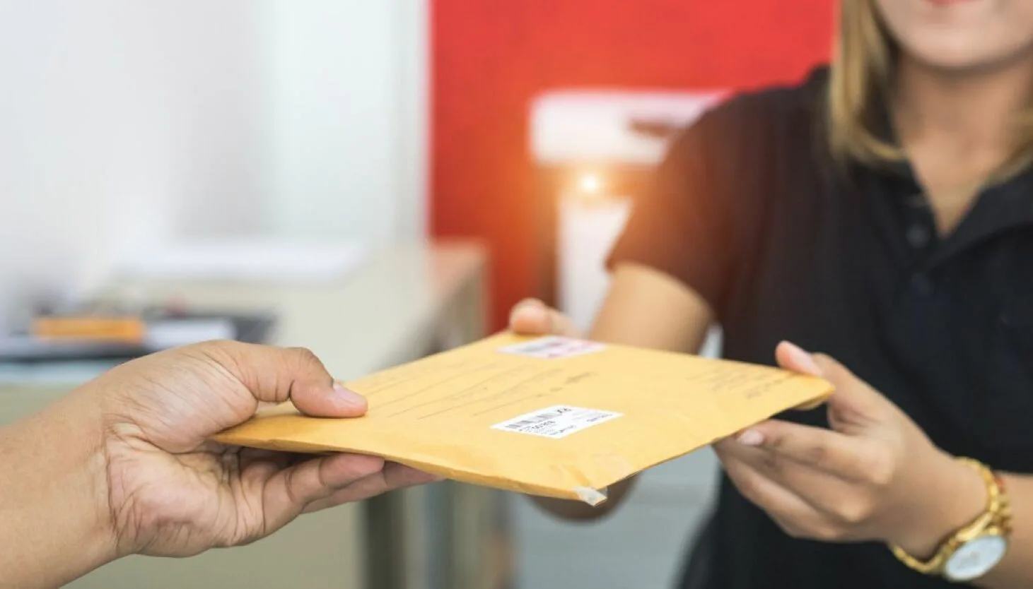 Important document envelope being handed over