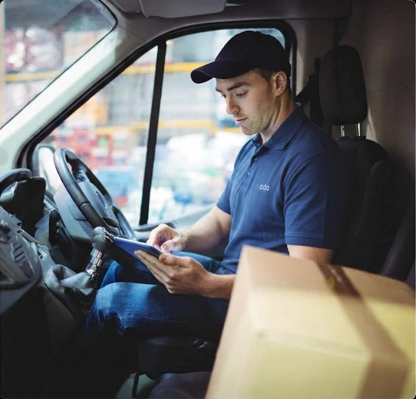 Courier driver in vehicle cab using mobile smartphone scanner