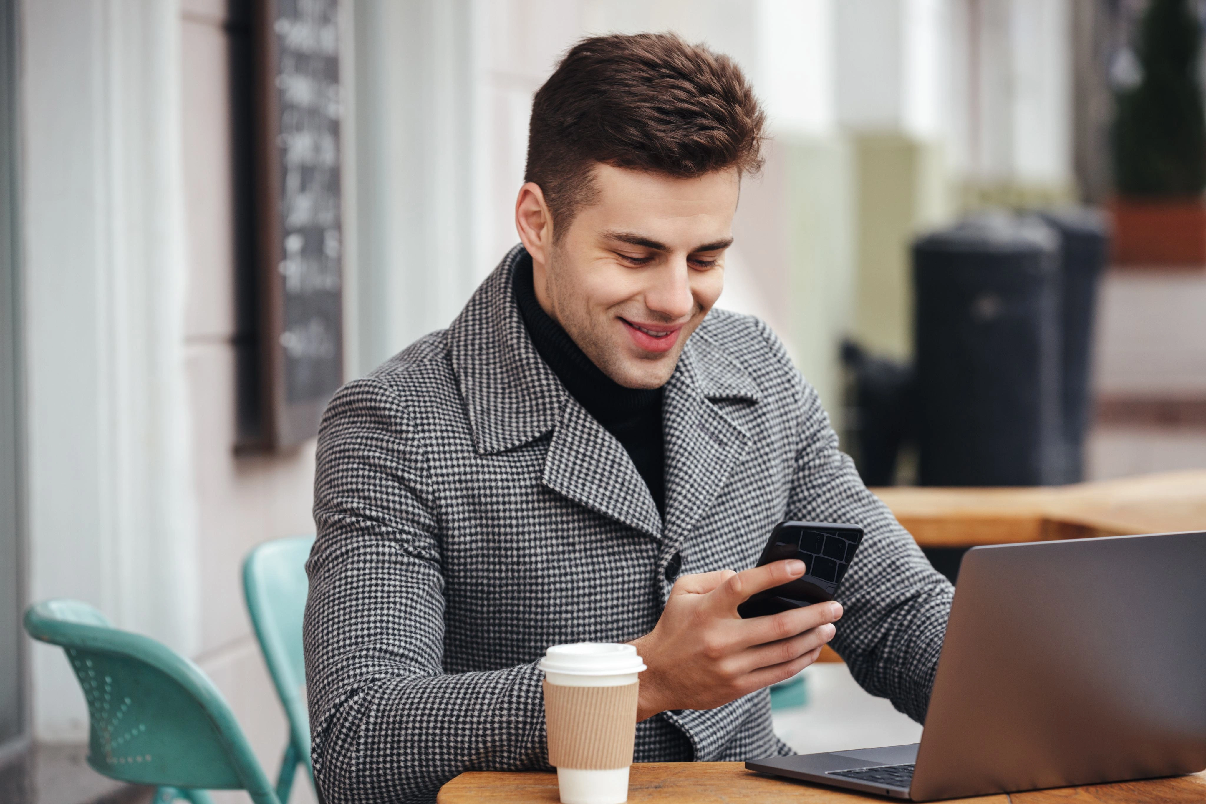 Business customer smiling while using mobile application