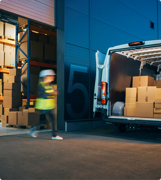 Courier loading parcels into a delivery van